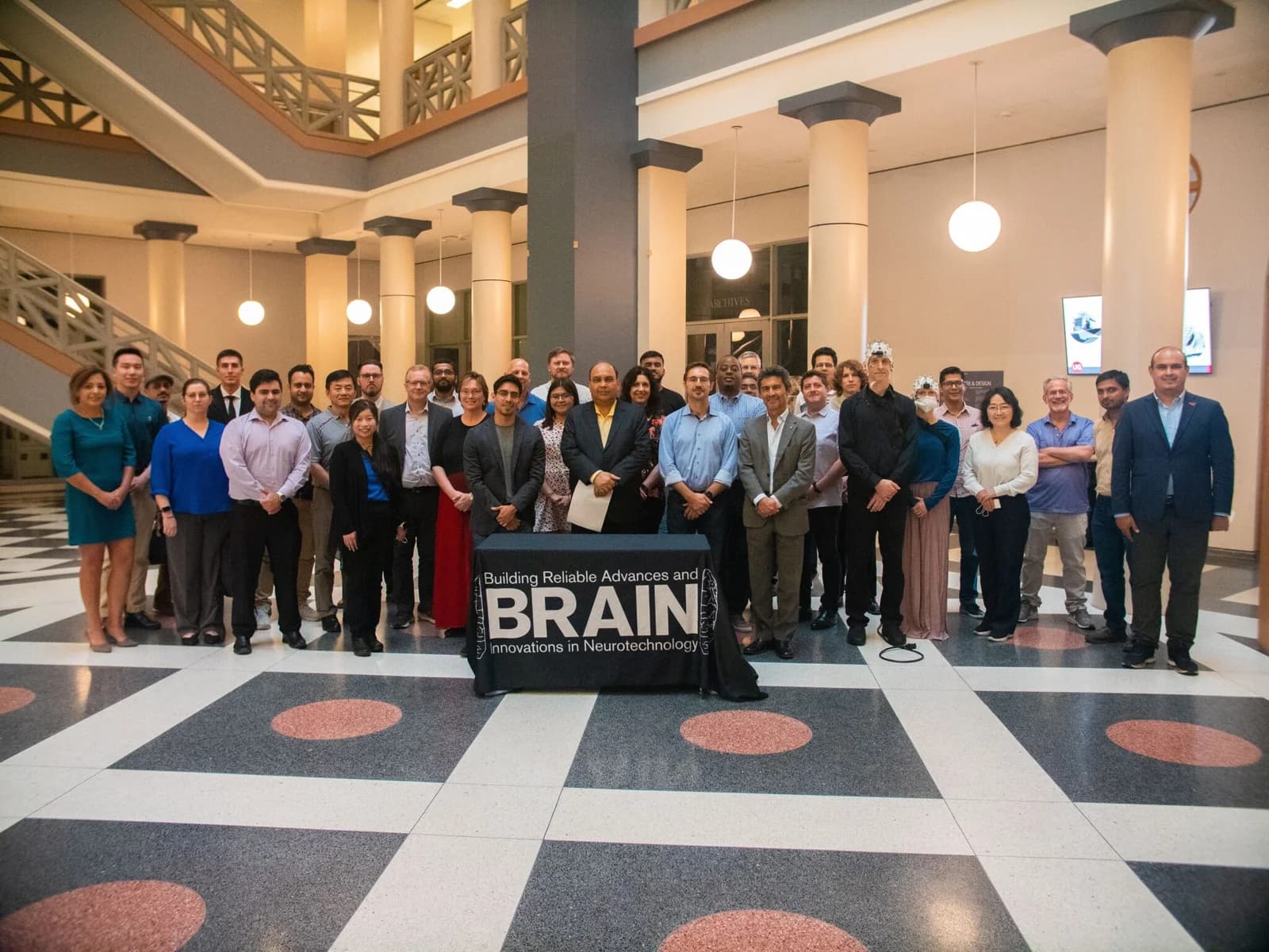 Attendees networking and presenting posters at the BRAIN Center annual meeting